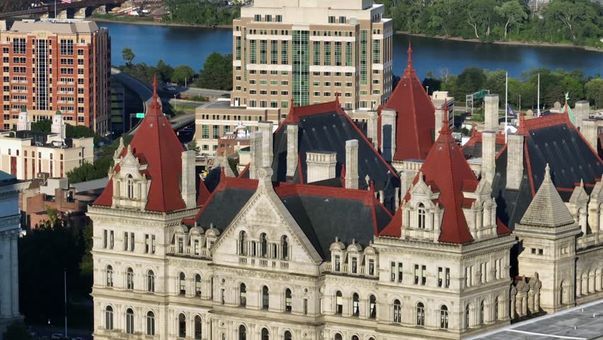 New York State capitol building in Albany and Department of Environmental Conservation in background. Aerial view. Sunny day in Albany, USA. Hudson River in distance. Sunset time. Zoom shot.