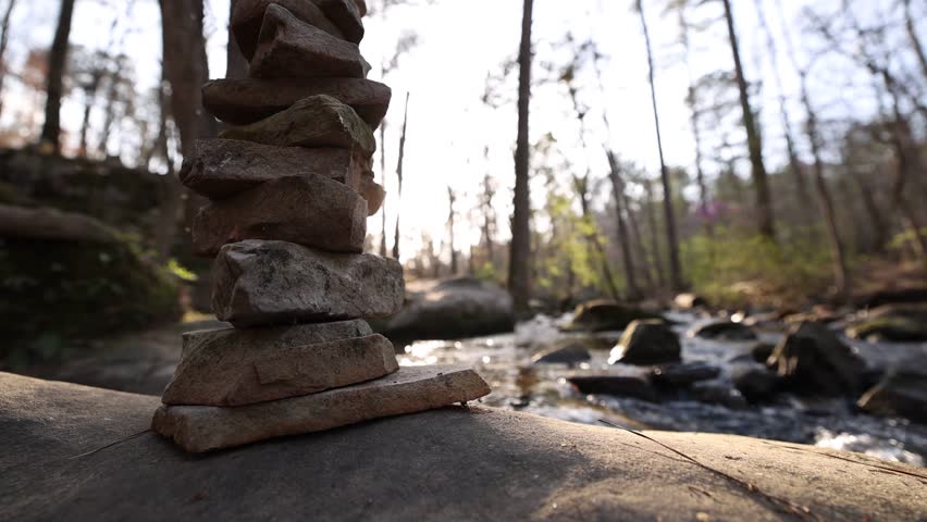 Low Wide Angle View Of Stacked Rocks Near Flowing River