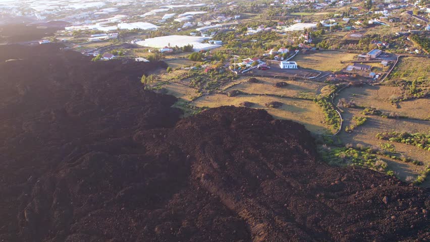 Aerial lava of Cumbre Vieja volcano two years after eruption with houses of small town on La Palma island Canary Islands Spain