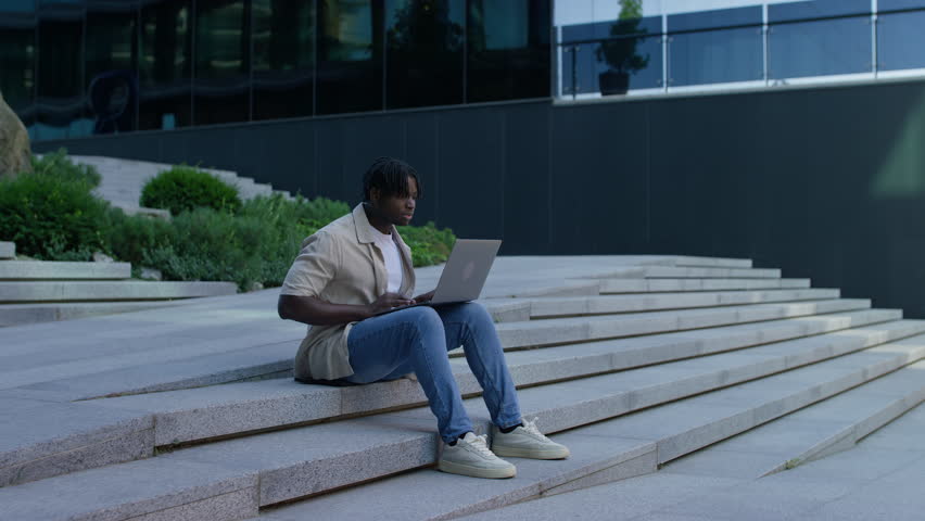 Man reacts excitedly to job offer on laptop