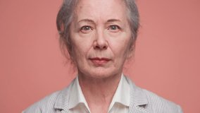 Confident senior woman in formal attire portrait on pink - Powered by Shutterstock - Get 15% off with code: PIKWIZARD15