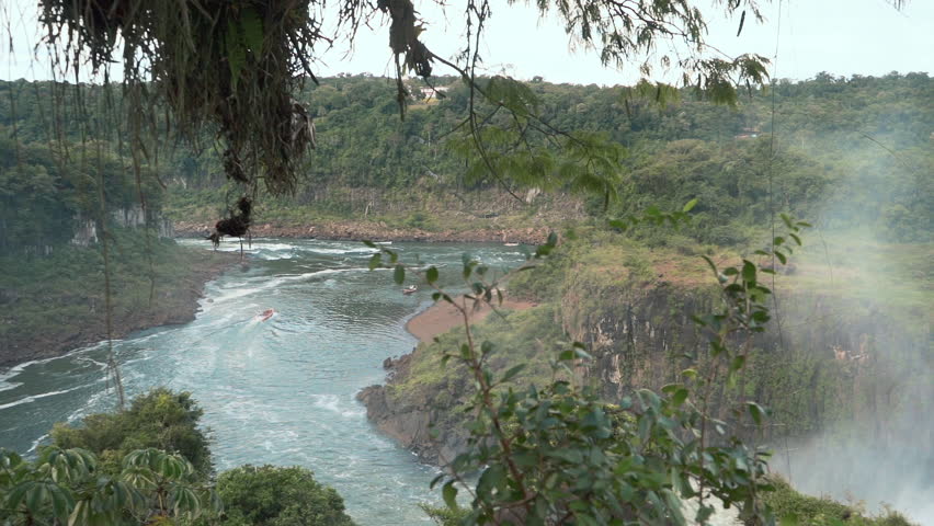 Real-time pan right across the Iguazú River gorge with waterfall mist — Iguazú National Park, Argentina