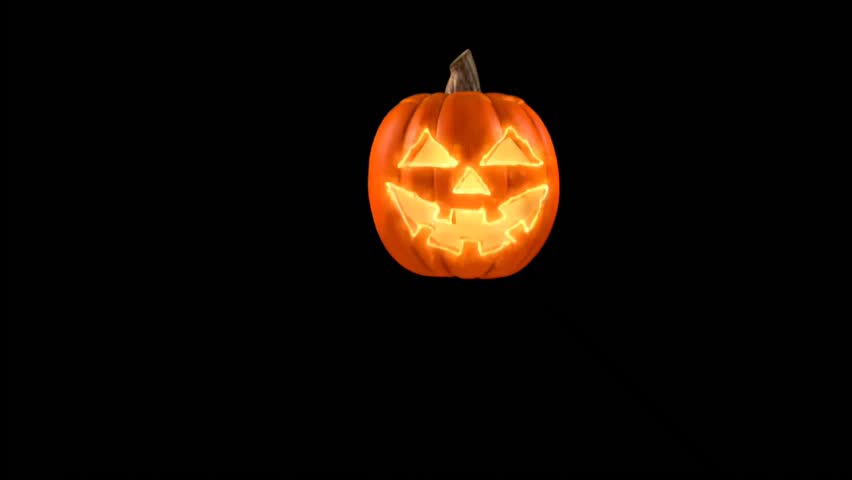 Illuminated Jack O Lantern Pumpkin on Dark Background
