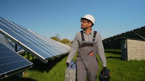 Middle eastern technician walking in solar panel farm - Powered by Shutterstock - Get 15% off with code: PIKWIZARD15