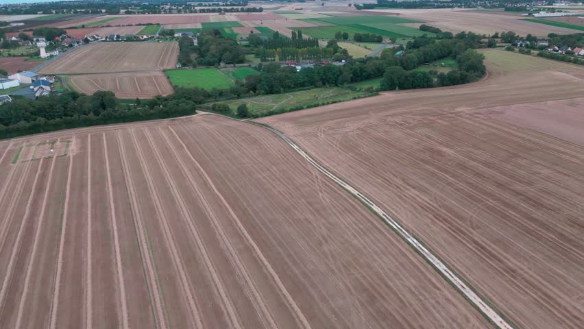 Aerial view of expansive farmlands with scenic countryside and remote fields.