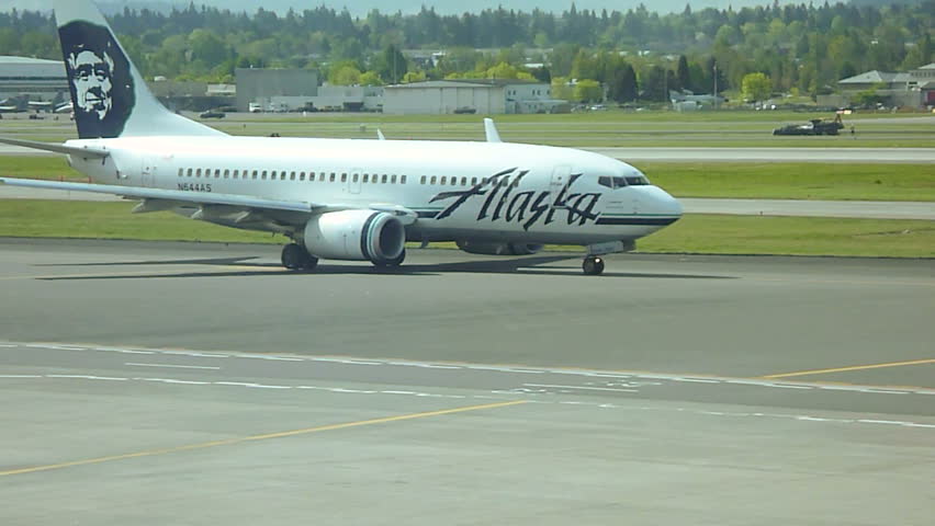 PORTLAND, OREGON AIRPORT - CIRCA 2013: Alaska Airlines airplane arrives at gate