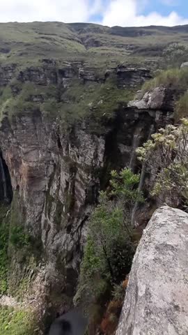 pov: person sitting on a rock at the edge of a cliff at a viewpoint in the Pati Valley, Chapada Diamantina, Bahia  