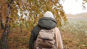 Woman with backpack walks through fog in birch forest. Hiking in autumn. Slow motion, from focus to defocused dreamlike ethereal look. Handheld shot - Powered by Shutterstock - Get 15% off with code: PIKWIZARD15