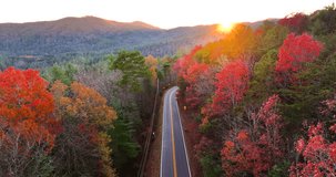 Blue Ridge Parkway at sunset in autumn. Scenic route between majestic mountain hills covered in golden and scarlet leaves - Powered by Shutterstock - Get 15% off with code: PIKWIZARD15