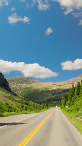 Stunning landscapes of Glacier National Park, going to the sun road featuring lush greenery, majestic mountains, and scenic roads surrounded by breathtaking natural beauty in every direction