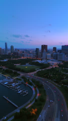 Stunning aerial footage showcases the Chicago skyline and waterfront at twilight, ideal for urbanthemed projects and cityscapes, perfect for fans of vibrant views and nightlife