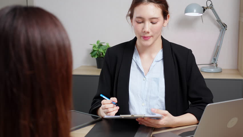 Young asian recruiter note during job interview examining with candidate in office, human resources hiring, HR manager job interview and writing document on clipboard, recruitment meeting.
