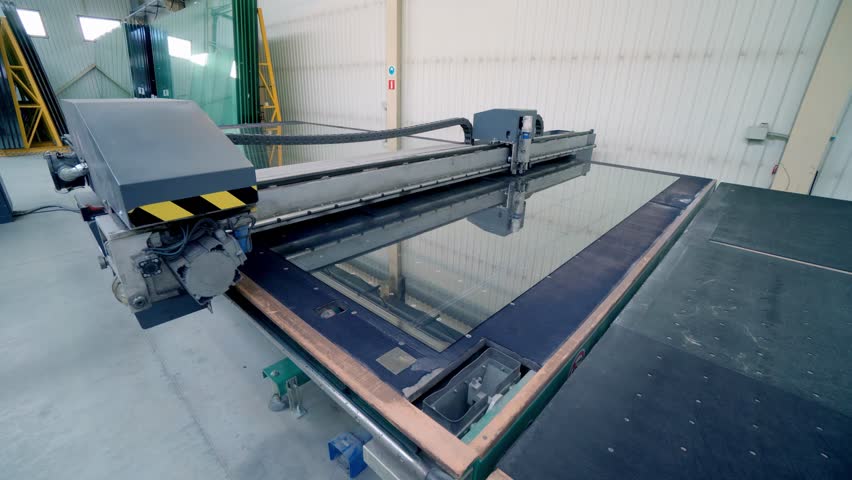 Industrial machine cutting glass panels precisely