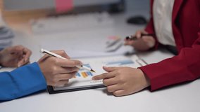 Two people are sitting at a table with a white board and writing on it. They are pointing at the board and discussing something. Scene is serious and focused - Powered by Shutterstock - Get 15% off with code: PIKWIZARD15