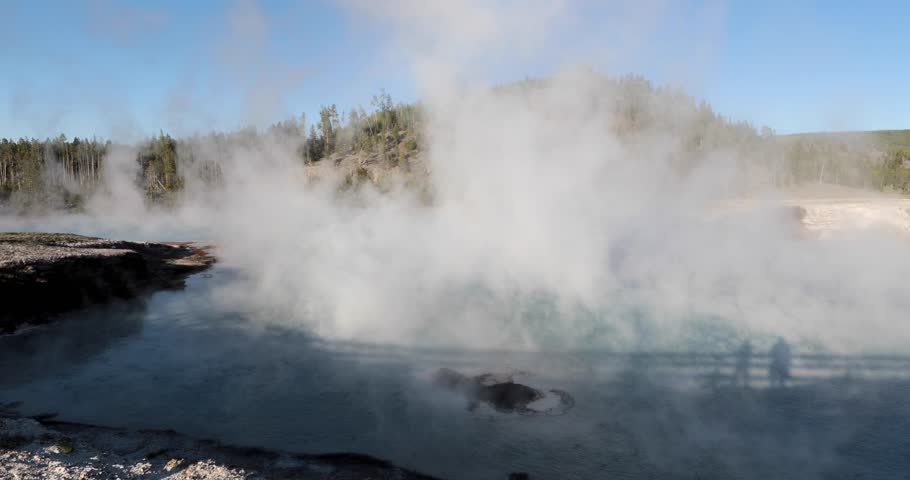 A large body of water with steam rising from it. The steam is white and the water is blue