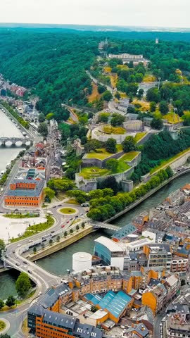 Vertical video. Namur, Belgium. Citadelle de Namur - 10th-century fortress with a park, rebuilt several times. Panorama of the central part of the city. River Meuse. Summer day, Aerial View, Point of