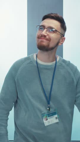 A Young Professional Found at Work, Wearing an ID Badge and Dressed in Casual Attire