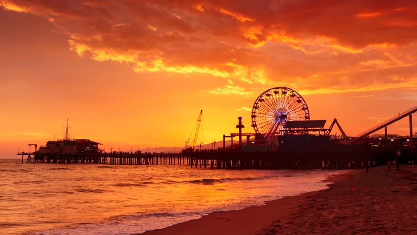 Sunset at Santa Monica beach pier, California. Zoom in on ferris wheel. HD Timelapse.
