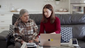 A daughter assists her senior mother with packing and shipping orders for their online store, working from home with a laptop and shipping supplies. - Powered by Shutterstock - Get 15% off with code: PIKWIZARD15