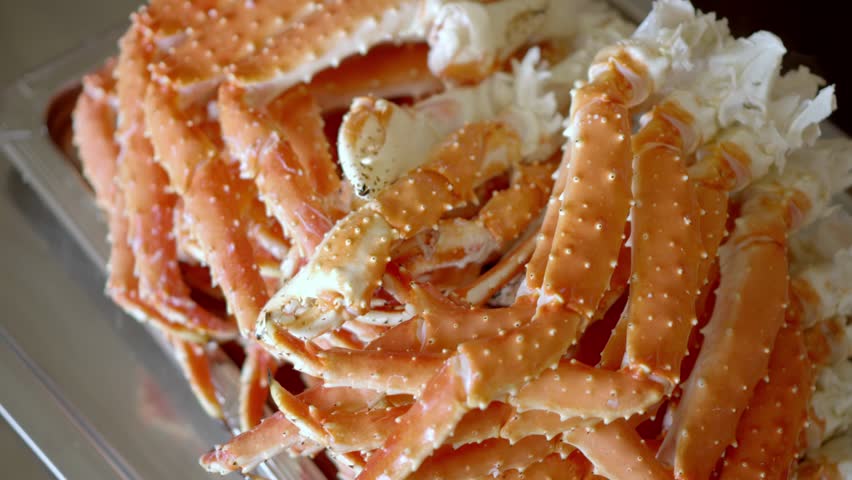 Freshly cooked crab legs piled together, showcasing seafood texture
