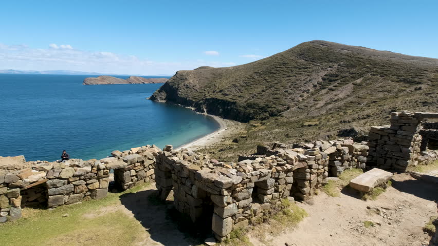 A sweeping pan shot showcases the mysterious Chincana Labyrinth on Isla del Sol, Copacabana, Bolivia. Highlights the ancient Inca ruins and the stunning views of Lake Titicaca.