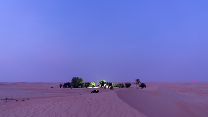 4 K beautiful moonrise time lapse over a desert sand dune. Vibrant sky transitions in a remote wilderness location.