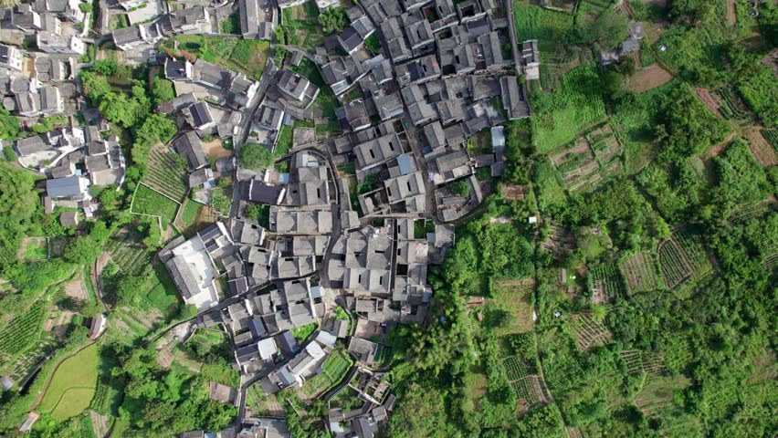 Drone view villages and farmlands among green mountains, high angel view rural landscape in autumn day, 4k real time footage b roll shot, Nanping village, Yixian, Anhui, China.