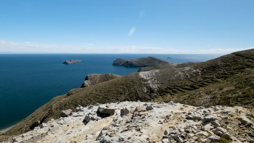 Experience the breathtaking panoramic beauty of Isla del Sol near Copacabana, Bolivia. This video captures the vast blue waters of Lake Titicaca.