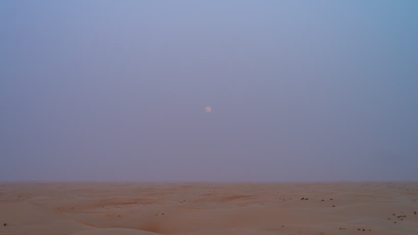 4 K beautiful moonrise time lapse over a desert sand dune. Vibrant sky transitions in a remote wilderness location.