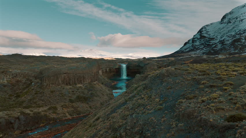 Surreal aerial view revealing the stunning Salto del Agrio waterfall surrounded by dramatic volcanic landscape in Patagonia, Argentina.