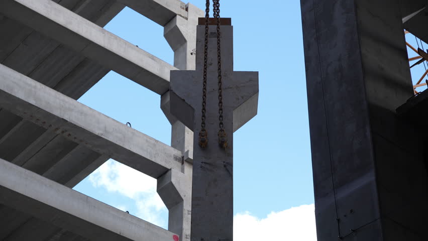 Concrete construction with crane lifting precast panel - Powered by Shutterstock - Get 15% off with code: PIKWIZARD15