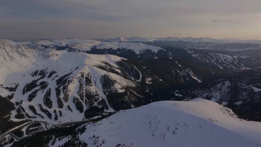 Winter Spring Arapahoe Basin Abay Ski Resort sunset golden hour Loveland Pass Colorado aerial drone Continental Divide Keystone Breckenridge ski trail runs windy road parking lot circle left motion