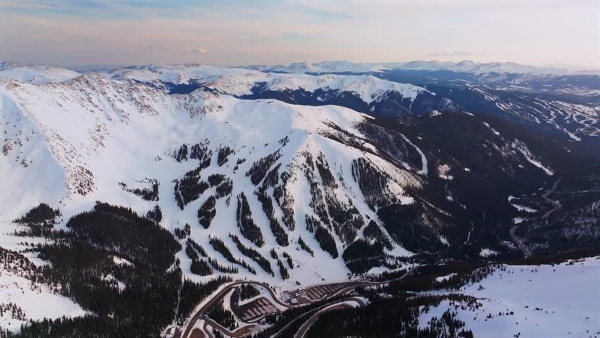 Winter Spring Arapahoe Basin Abay Ski Resort sunset golden hour Loveland Pass Colorado aerial drone view Continental Divide Keystone Breckenridge ski trail runs windy road parking lot circle left