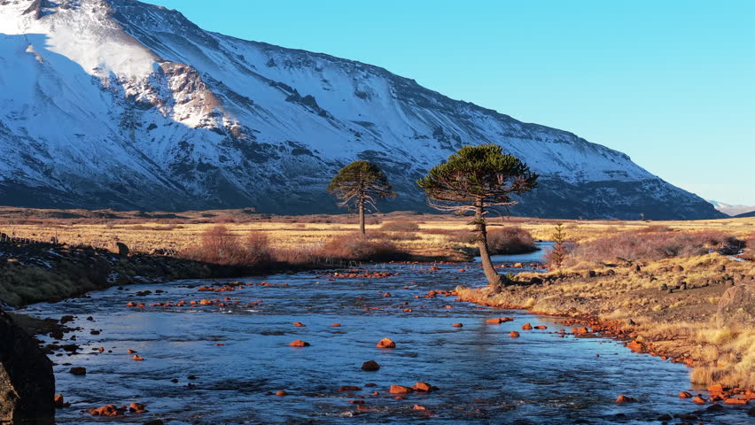 Aerial Drone Establishing fly River Caviahue, Patagonian Mountains in Neuquén Argentina
