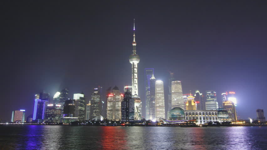 Time lapse of Shanghai skyline and tour boat passing in the Huangpu river at