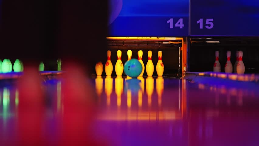 Colorful RGB bowling strike captured in cinematic slow motion perspective
