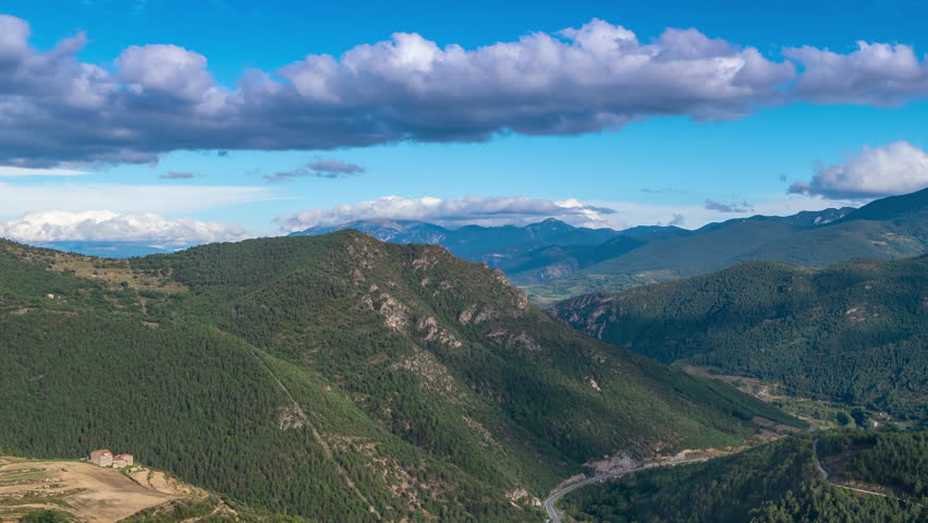 Aerial view of a mountain valley in the Pyrenees of Catalonia, Spain.
Landscape with fast movement of clouds in the sky, sunbeams and shadows on the ground. Camera movement: Pan Right. Time Lapse. 4K