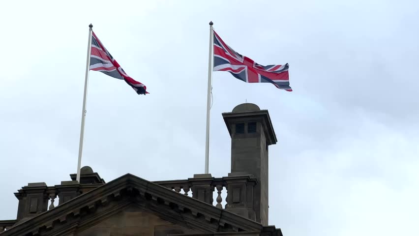 Close up view of uk united kingdom flags blowing in the wind south shields north east england uk