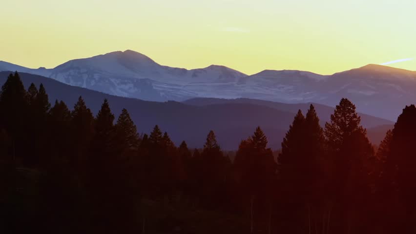 Mount Blue Sky front range Mt Evans 14er peak parallax aerial drone Evergreen Colorado scenic bypass golden hour sunset yellow sky Rocky Mountains layers Arapaho National Forest spring circle right