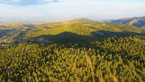 Sweeping cinematic aerial of Colorado Rockies at golden hour, golden light over rugged ridges, shimmering alpine lakes, and lush green meadows, high-quality 4K drone footage perfect for nature lovers. - Powered by Shutterstock - Get 15% off with code: PIKWIZARD15