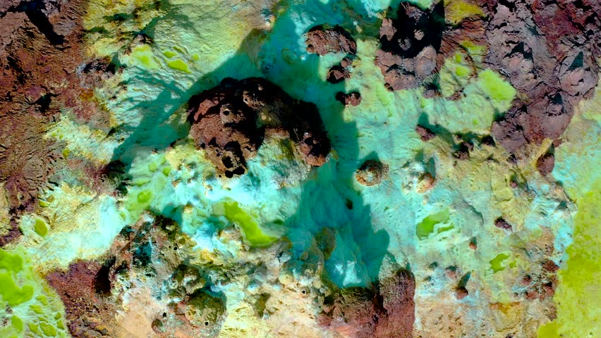 An aerial view of vibrant sulfur flats and mineral formations in Danakil Depression, Ethiopia, showing colorful geological activity