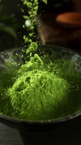Super Slow Motion Detail Shot of Sprinkling Matcha Powder . Filmed on High Speed Cinematic Camera at 1000 FPS