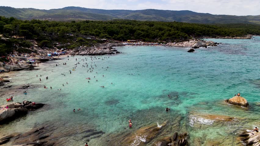 Kavourotrypes or Orange Beach in Sithonia, Halkidiki, Greece. Incredible beach with clear blue water  Aerial panoramic drone view from above, top view from drone. Summer holidays in Europe, amazing sc