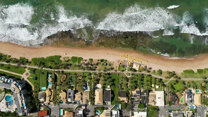 Top Down View of Waves Crashing to the Beach With Rocks and Reefs Along the Coast, Near Salvador City in Bahia