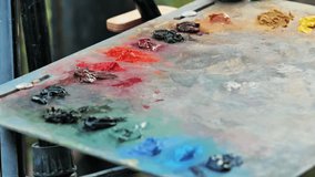 Oil paint tubes laying on an artist's palette creating a colorful composition - Powered by Shutterstock - Get 15% off with code: PIKWIZARD15