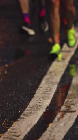 Night marathon runners crowd, sportsmen participants start running the half-marathon in the night city streets, crowd of sportswomen joggers in motion, group athletes outdoor training competition 