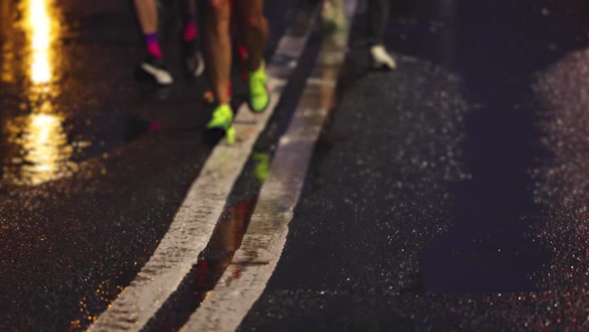 Night marathon runners crowd, sportsmen participants start running the half-marathon in the night city streets, crowd of sportswomen joggers in motion, group athletes outdoor training competition 