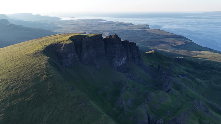 Explore Isle of Skye with breathtaking aerial views of rugged landscapes and coastal cliffs in Scotland at sunset