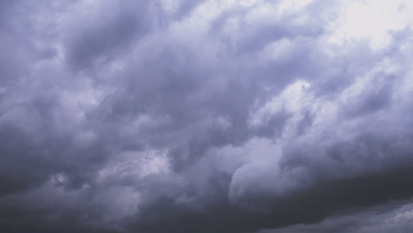 Ominous time-lapse of dramatic thunderclouds rotating and gathering before and after rainfall, creating a powerful, atmospheric loop perfect for moody weather, storm visuals, and cinematic impact.