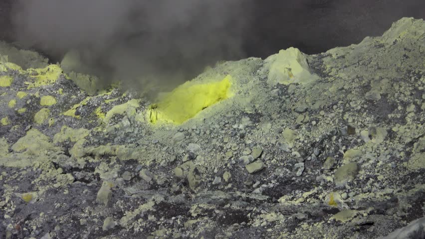 A volcano crater with an acid lake (explosion lake) and steaming fumaroles (solfatare) and hot springs. Sulawesi. Indonesia